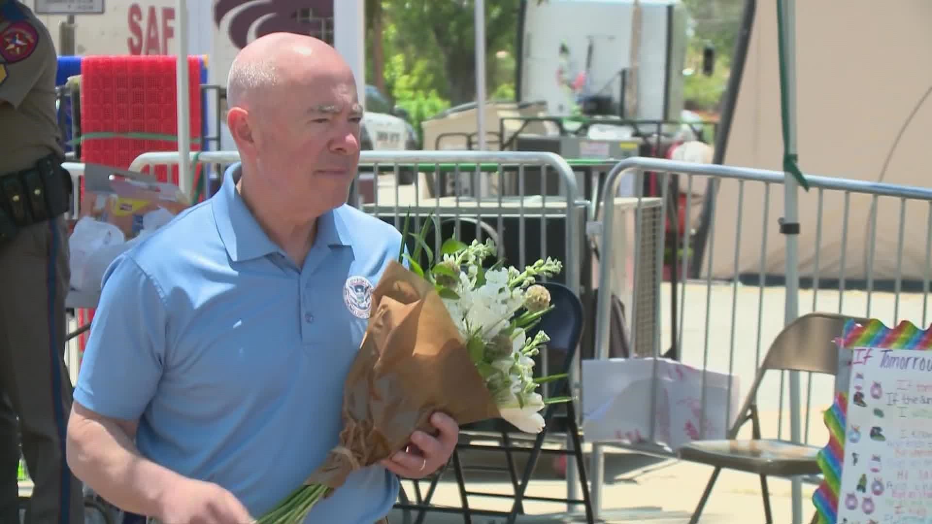 Secretary Alejandro Mayorkas left flowers at the memorial, and spoke to State Senator Roland Gutierrez.