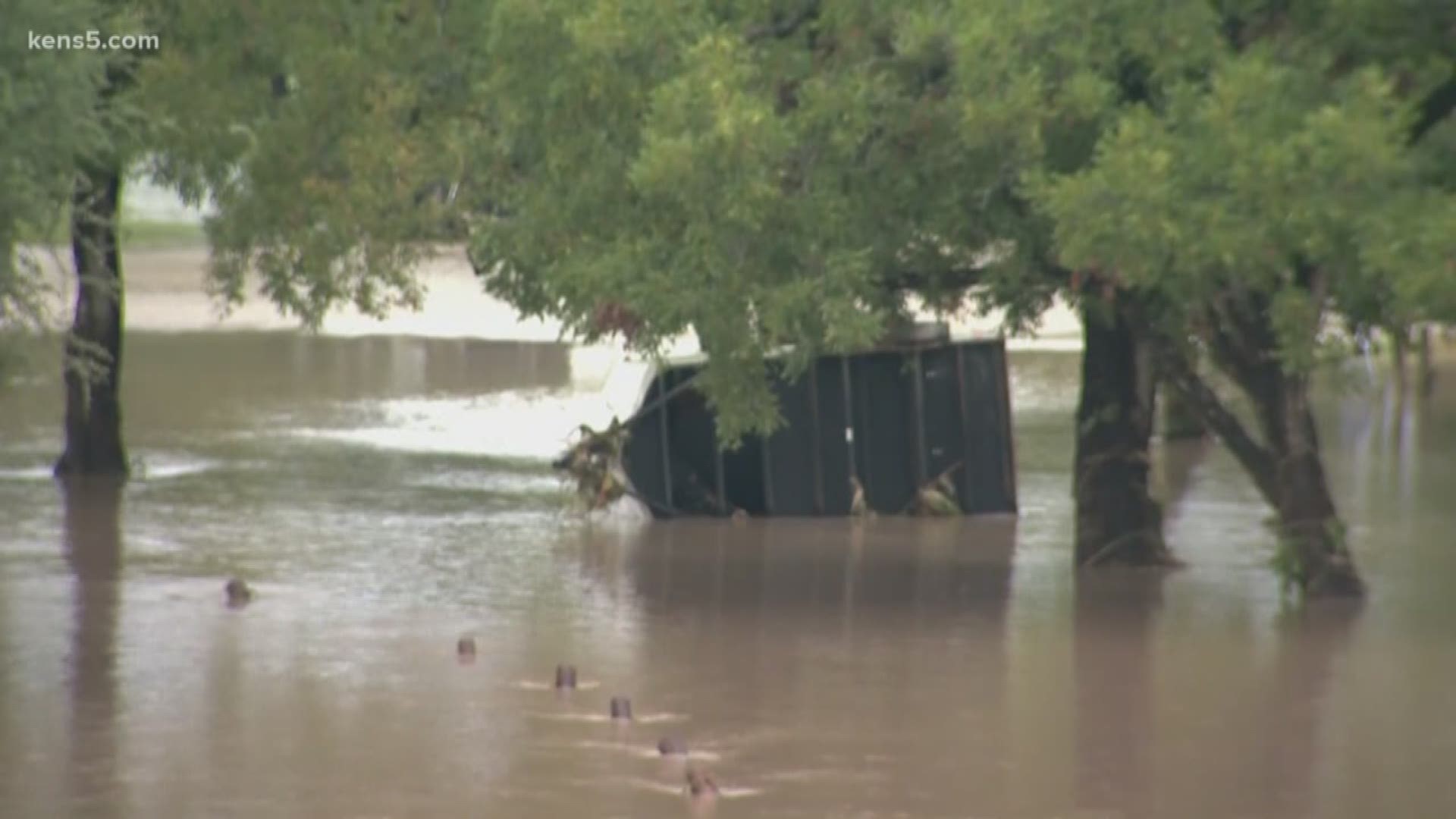 One woman survived by clinging to flood debris as she was swept down the river.