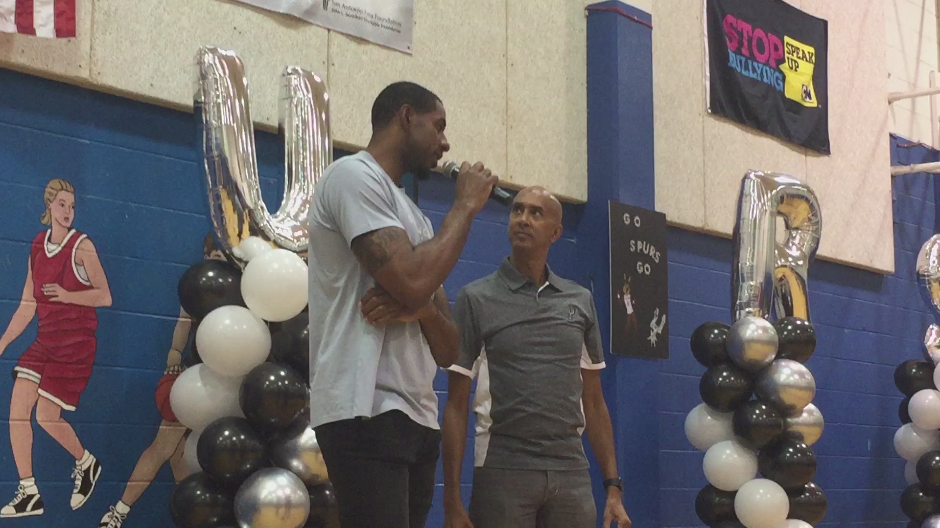 Spurs forward LaMarcus Aldridge talks to kids at his back-to-school party Friday.