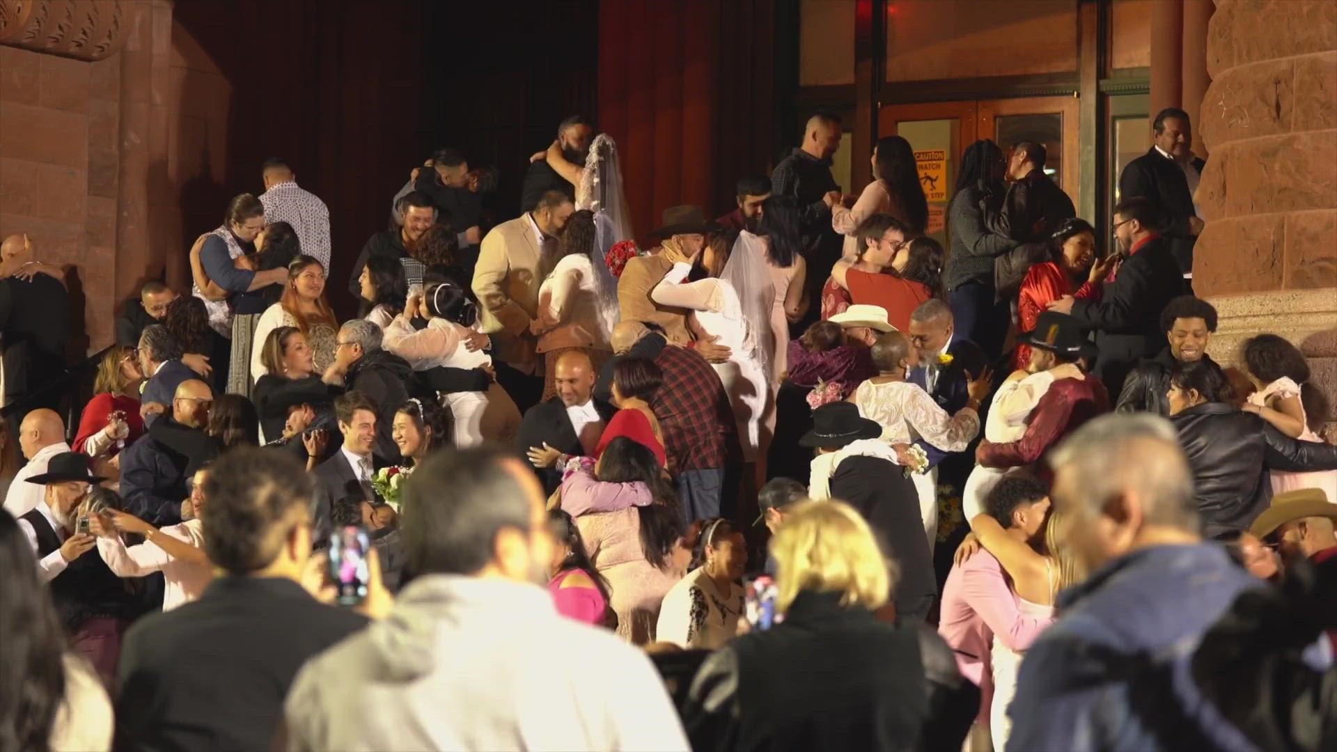 Hundreds of people gathered at the steps of the Bexar County Courthouse where County Clerk Lucy Adame-Clark conducted the free wedding ceremony at 12:01 a.m.