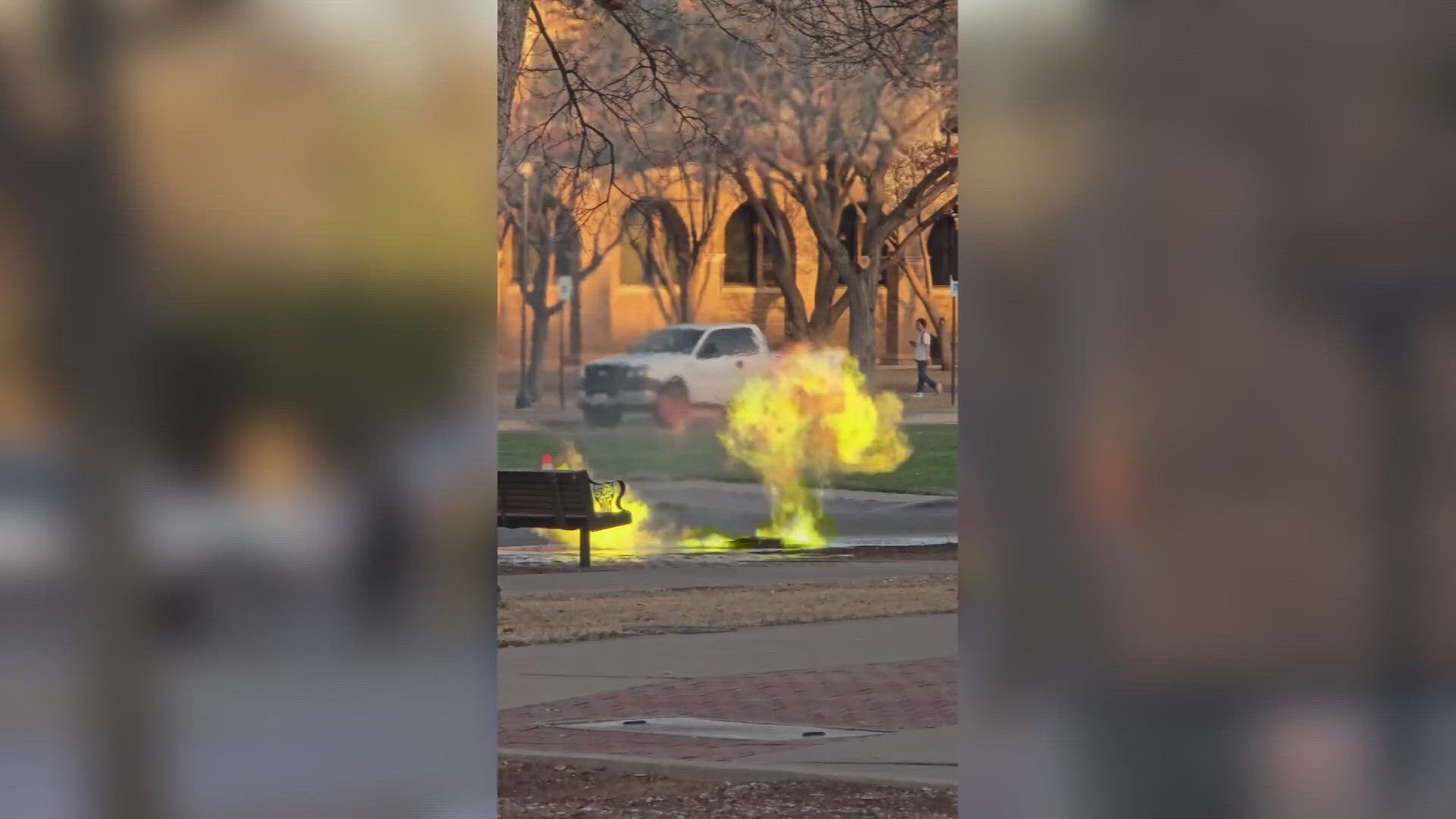 Video shows bright green and yellow flames shooting out from a manhole cover.
