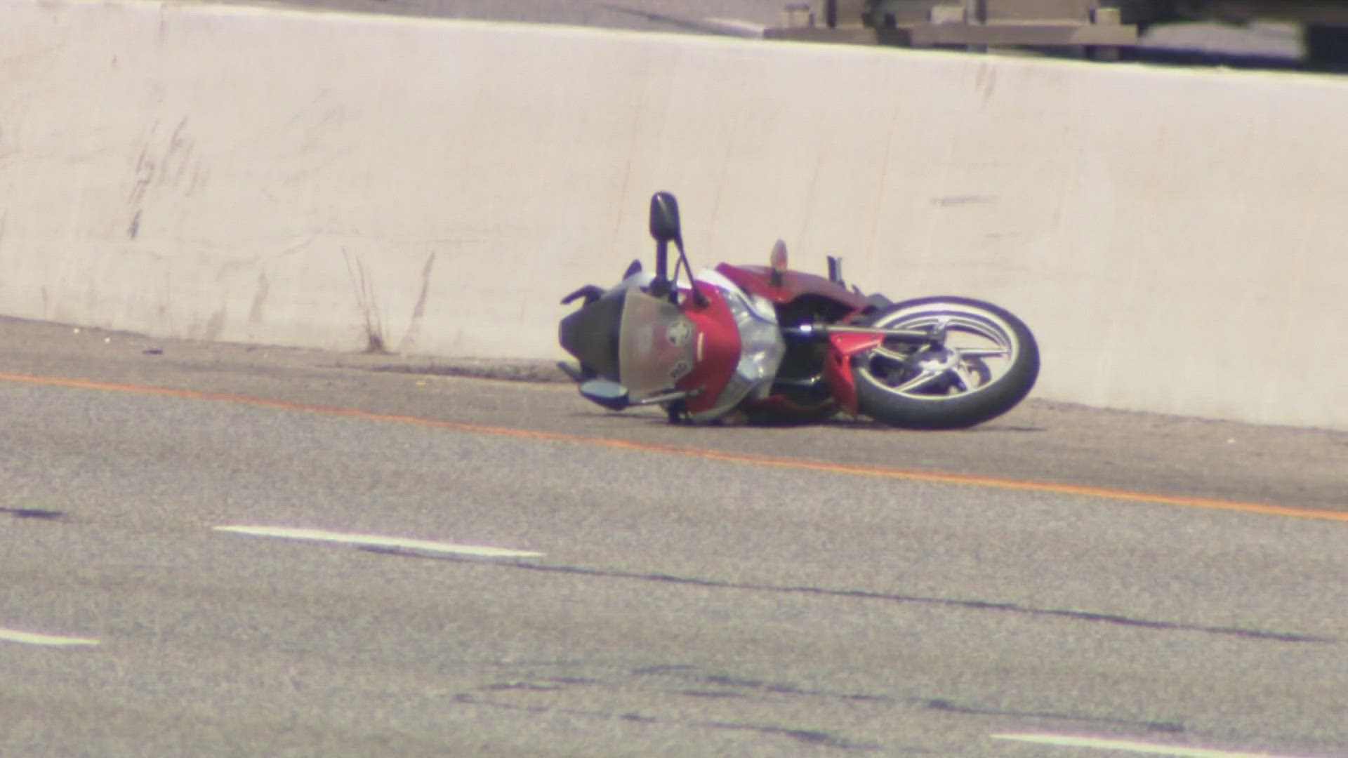 Police say a man on a motorcycle was weaving in and out of traffic when he was hit by a car. The man died at the scene and the crash remains under investigation.