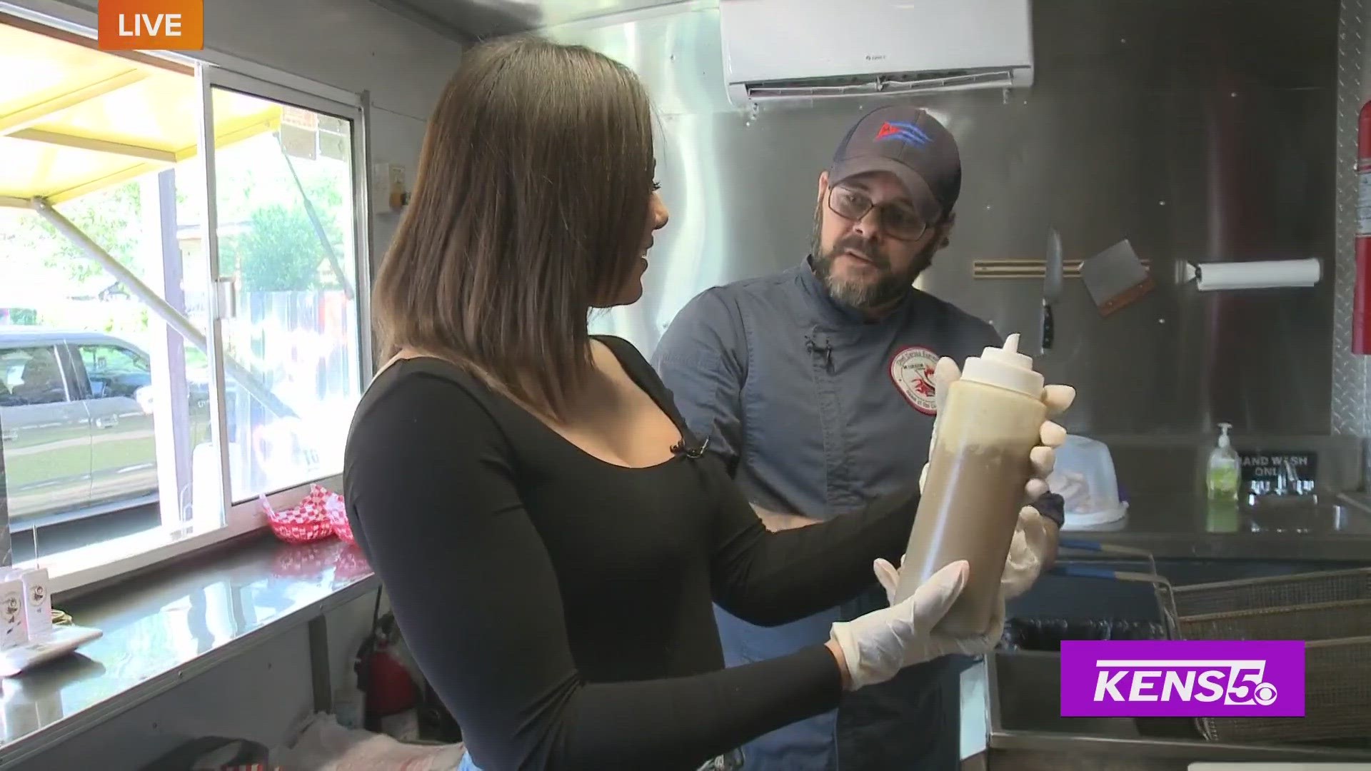 Carlos Espino with Mi Corazon International food tuck shows Clarke how he makes an authentic Cuban-style sandwiches.