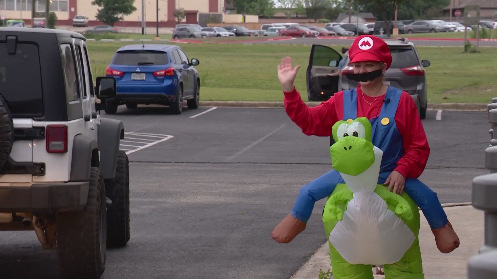 Adrian Baker dresses up every day for student drop-off at Walnut Springs Elementary School.