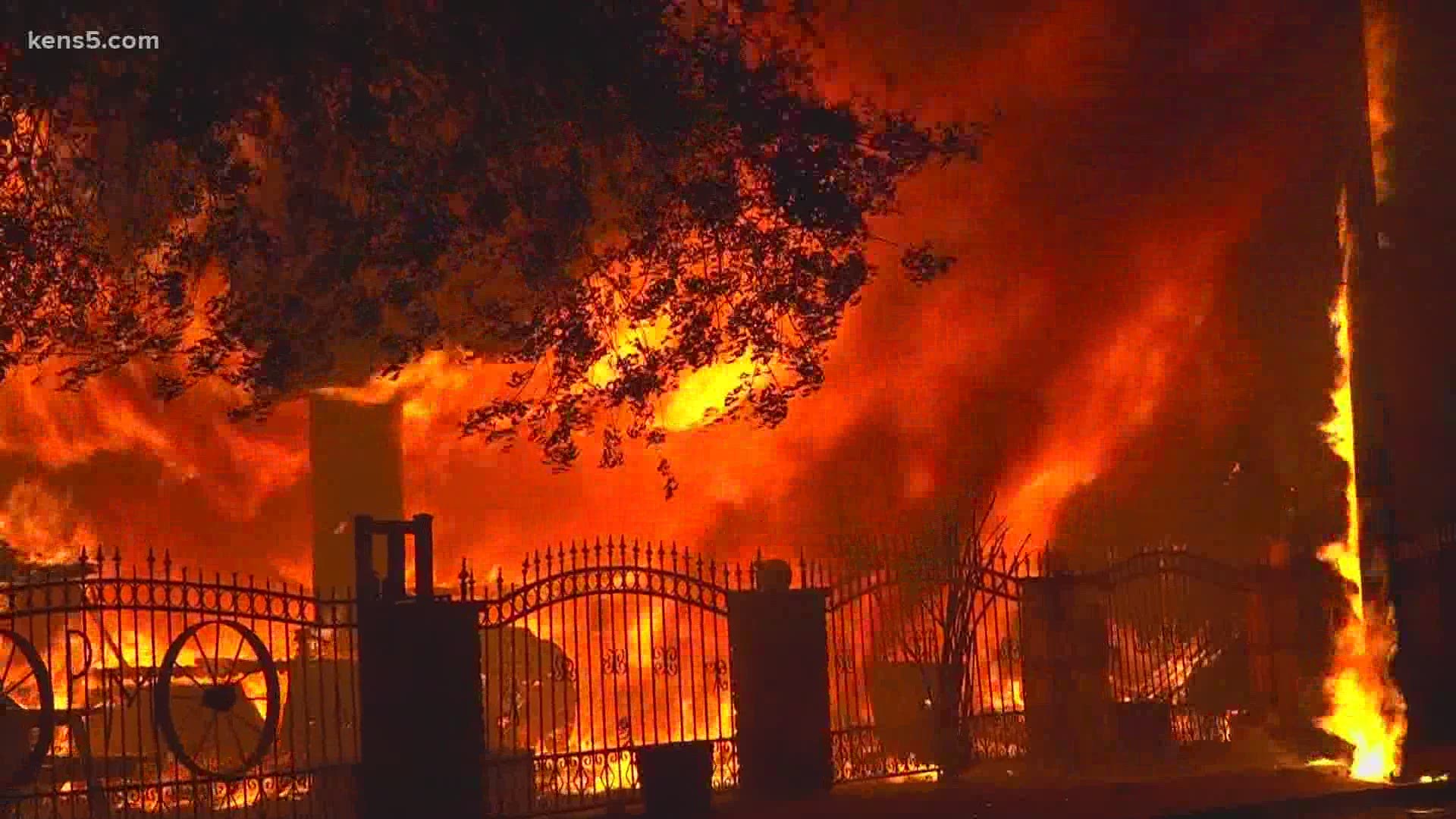 A large storage building next to a home went up in flames, according to the San Antonio Fire Department.