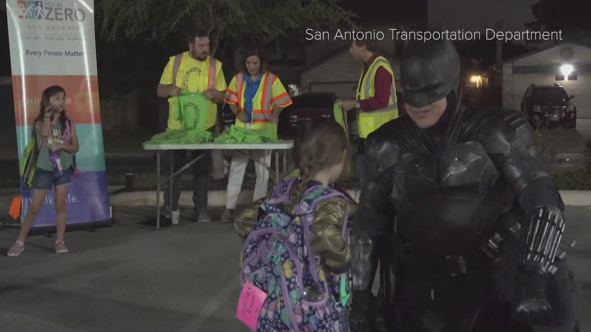 The caped crusader joined nearly 200 students, parents and teachers who made th etrek as part of National Walk, Bike and Roll to School Day.