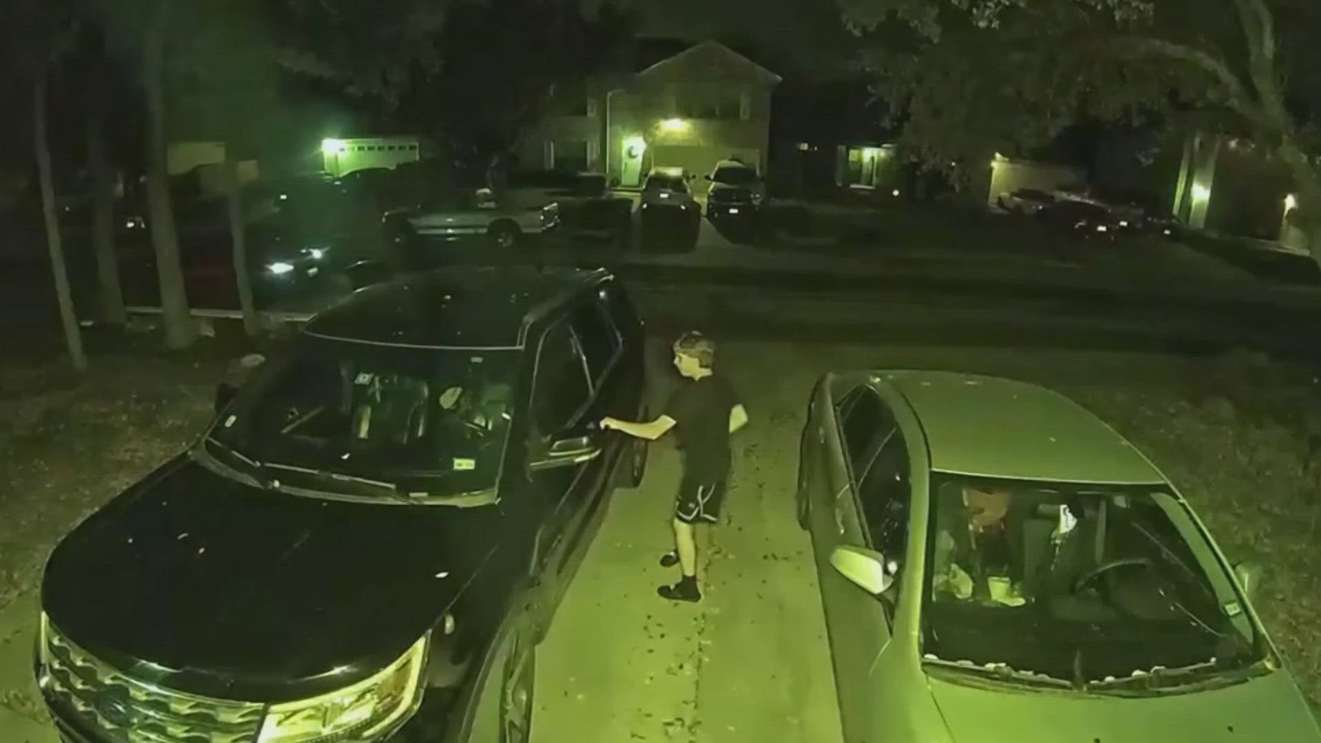 Surveillance video shows two young men rummaging through the SUV.