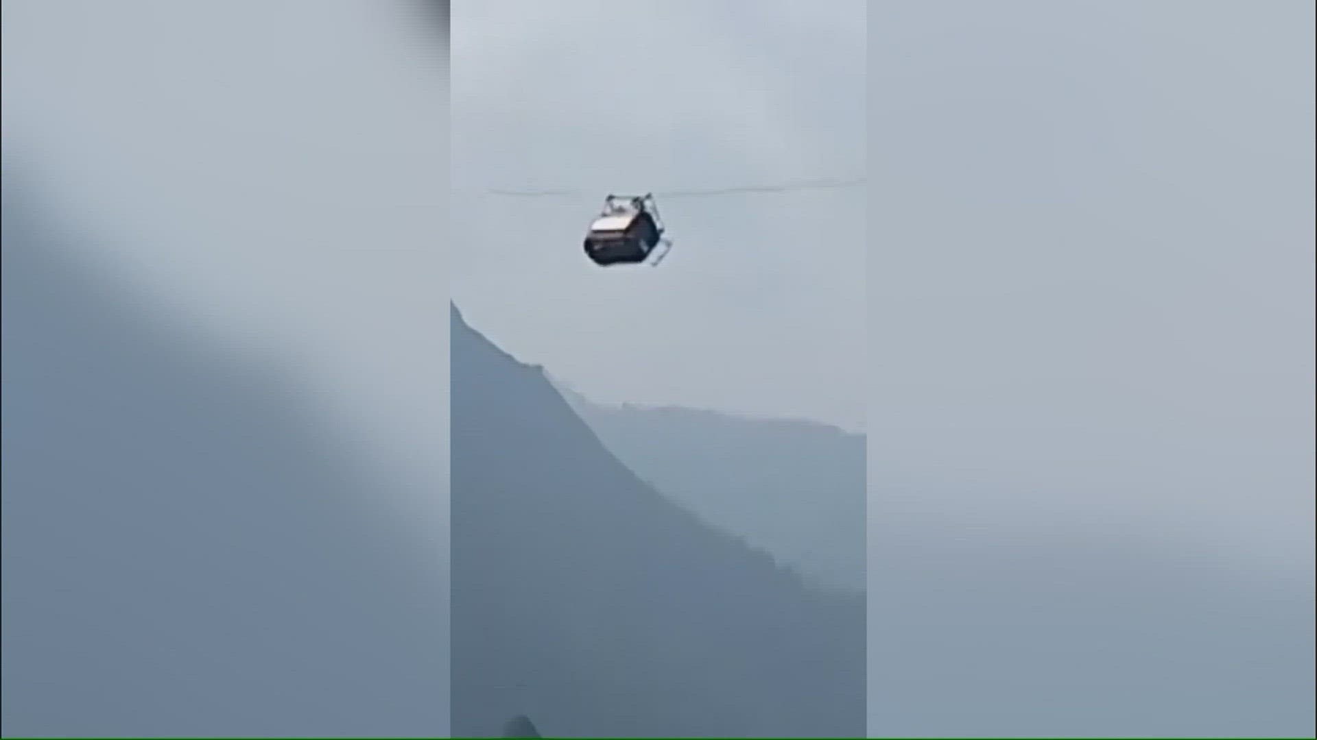 Seven students and one teacher are trapped in a cable car dangling 900 feet above a ravine in Pakistan after a line snapped.