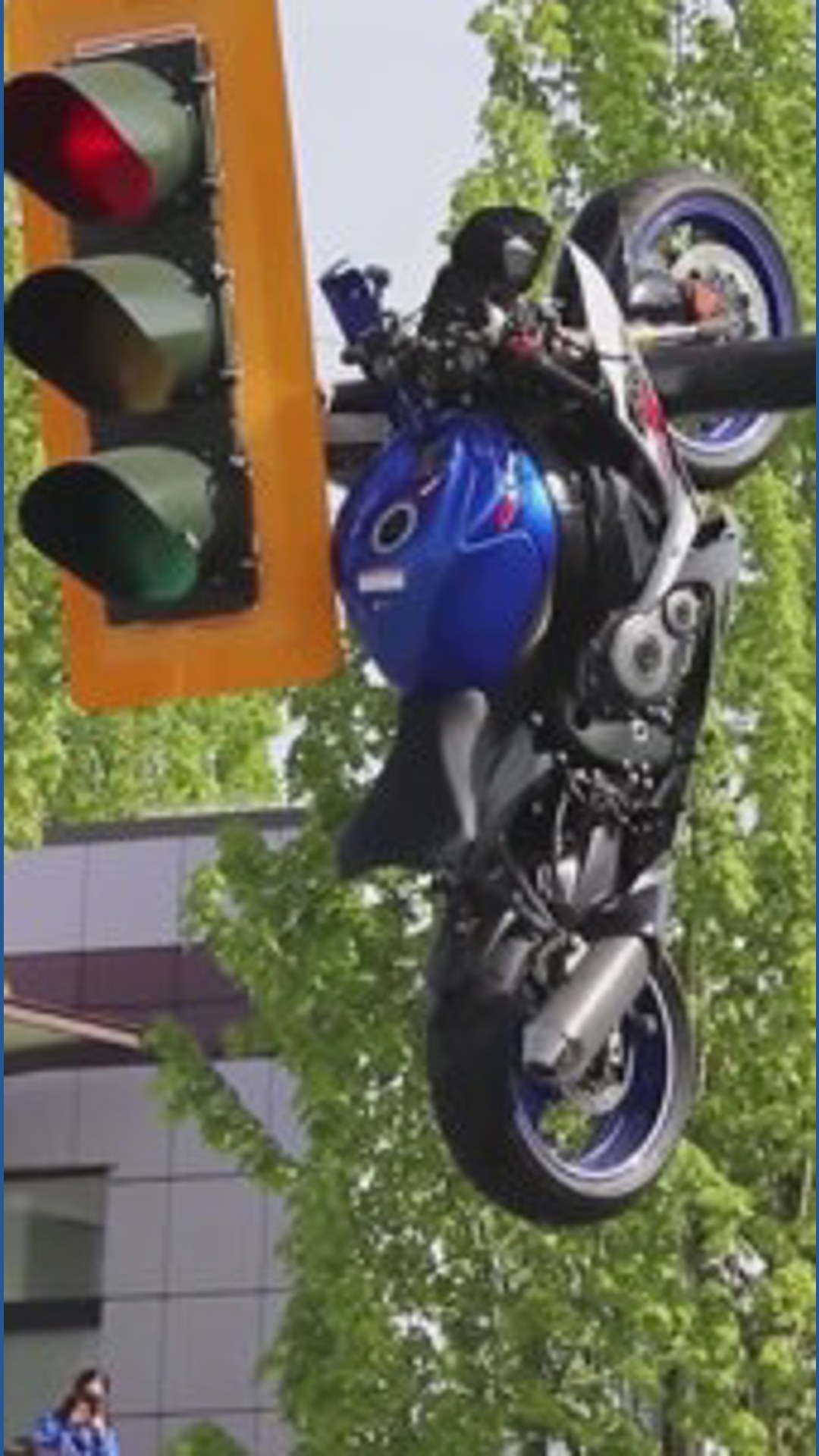 Motorcycle crash in Canada leaves bike hanging from the light in the ...