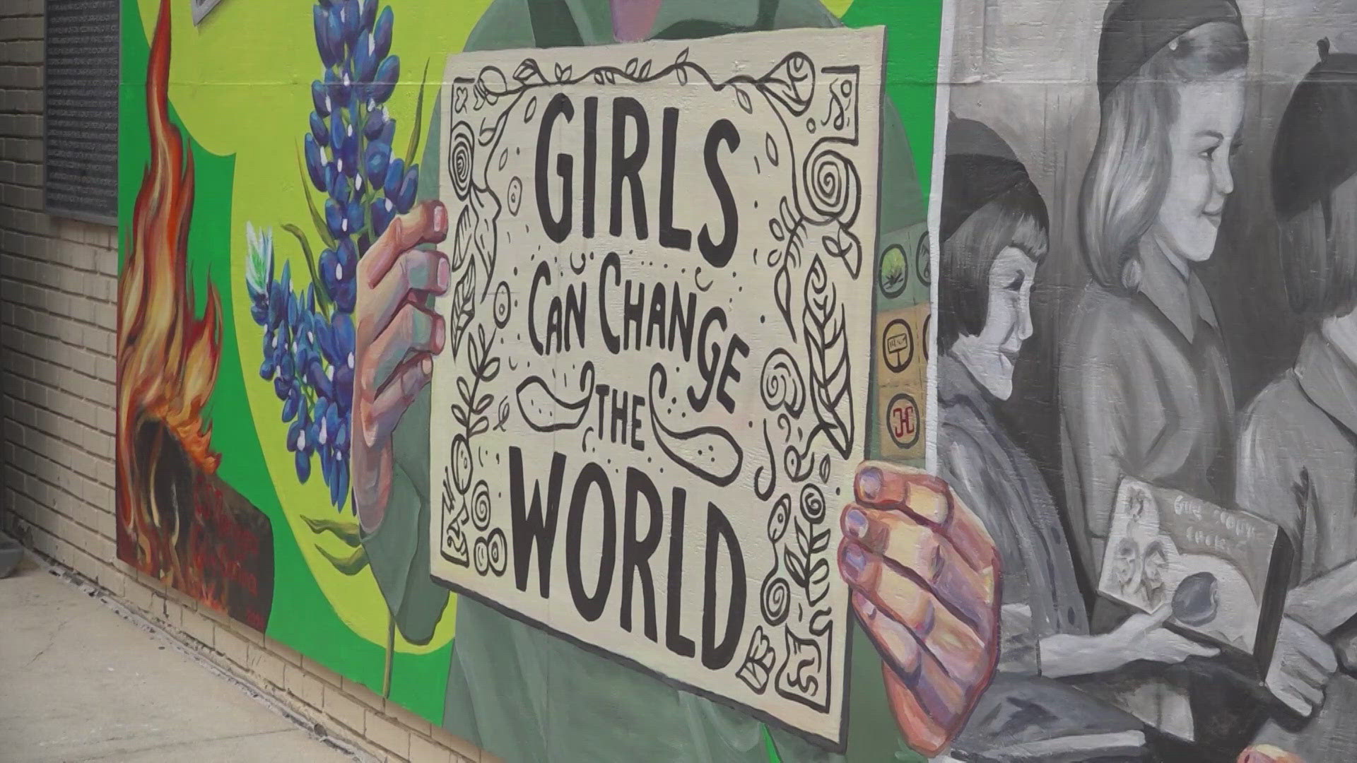 The mural is located in Main Plaza and celebrates 100 years of Girl Scouts.