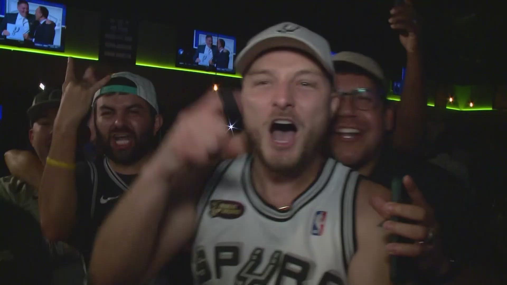 Bars were packed and drivers honking downtown Tuesday night after the Spurs struck draft lottery gold.