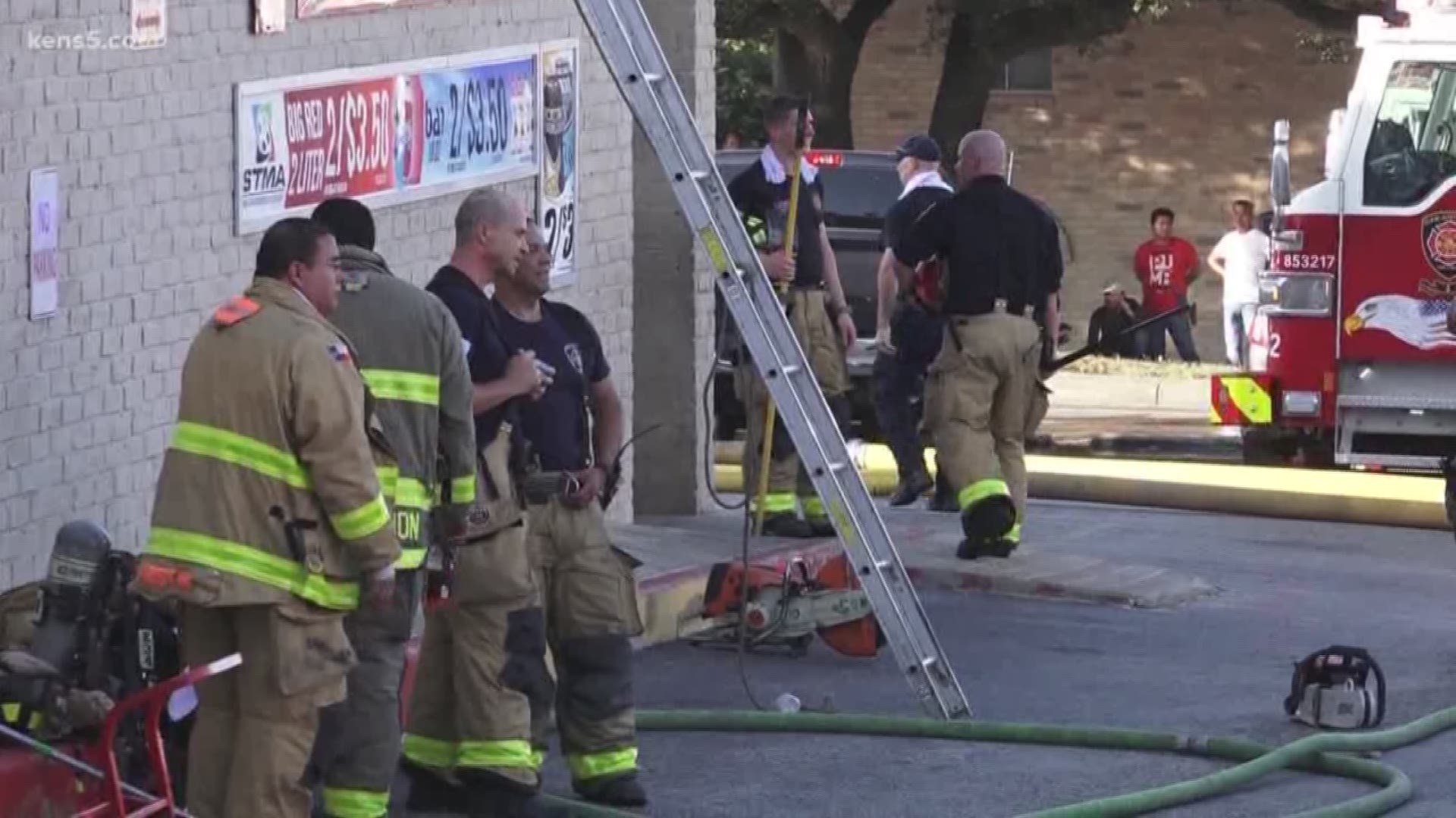 According to San Antonio fire chief Charles Hood, a fire originated in a beauty salon and spread to an adjacent food mart and laundromat. About 100 firefighters were called to the scene.