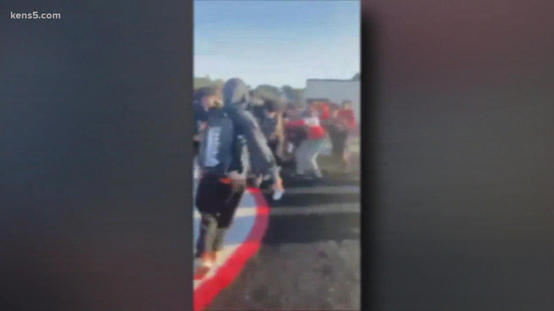 KENS 5 obtained two videos showing a mob of students pummeling another student at the Churchill High School football field.