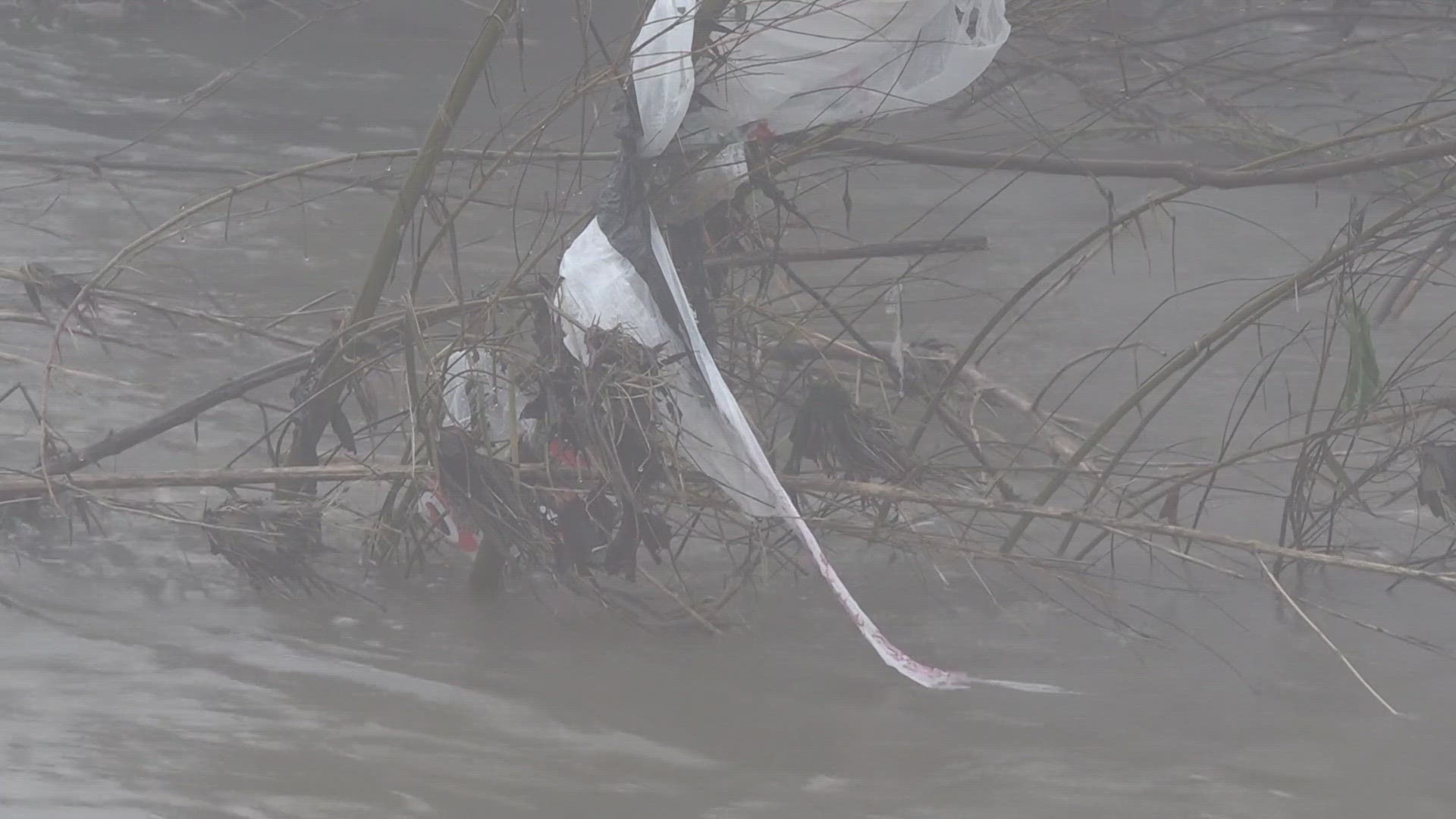 The recent rain showers have filled the river with trash.