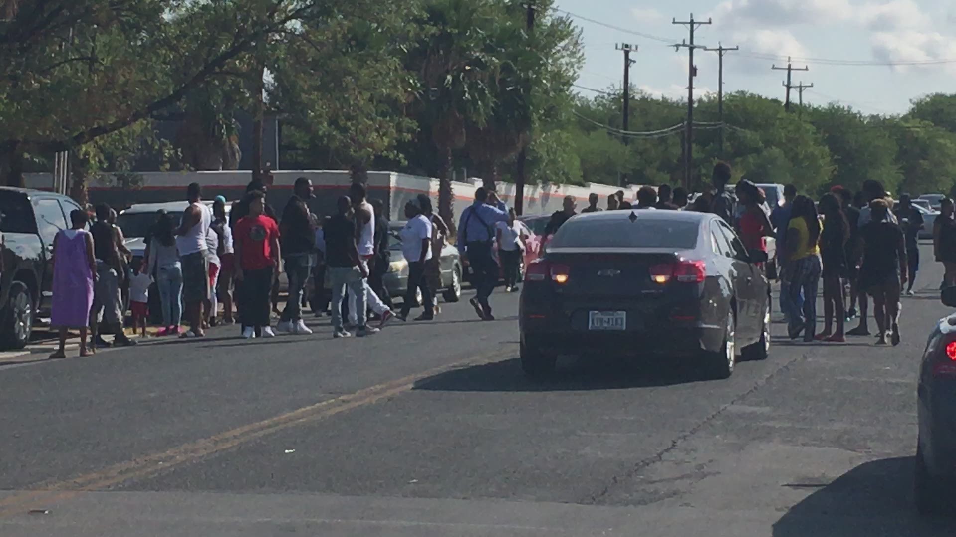 Because the day was hot and the wait for answers was long, a screaming and shoving confrontation spilled into the street.