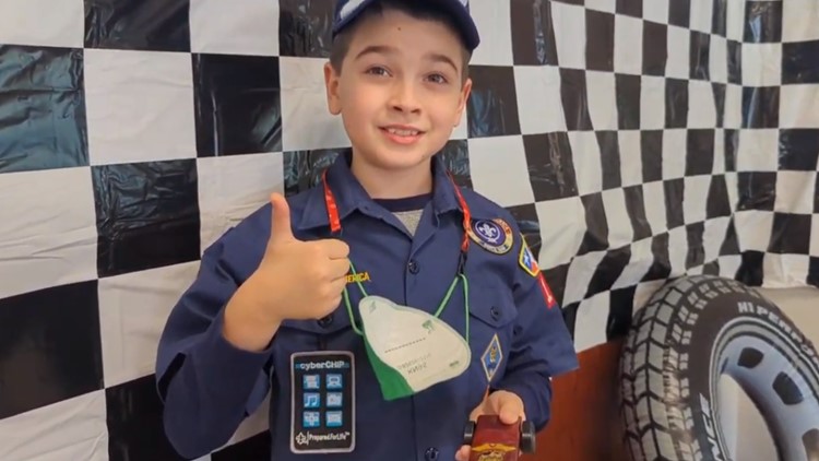 Third-grader all smiles after big Pinewood Derby win