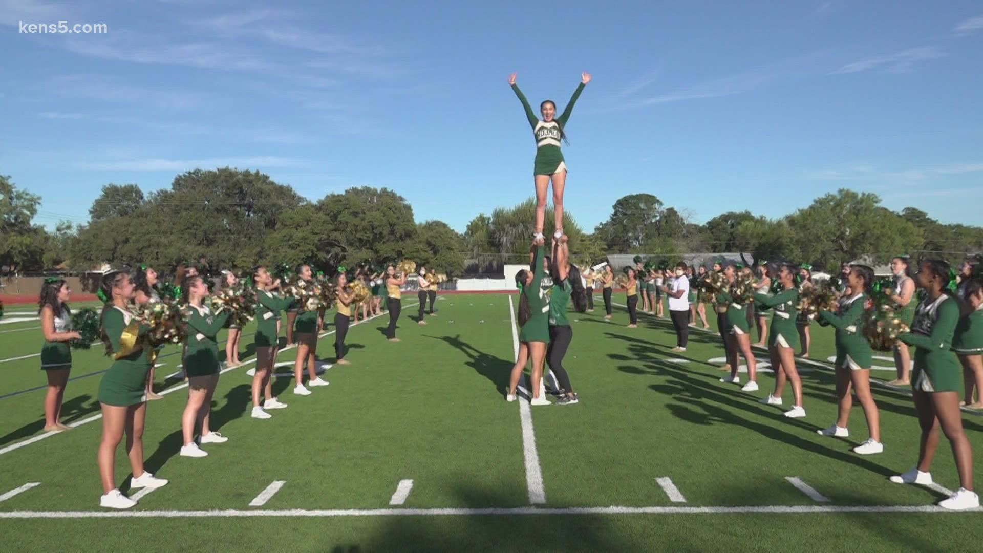 The cheer and dance squads all work together to lift and support each other.