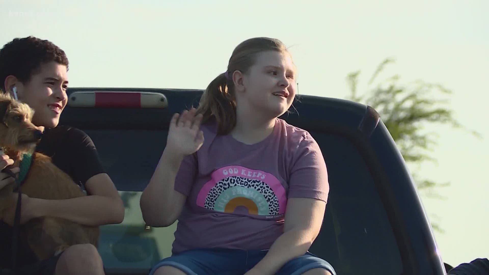 On Thursday evening, Abby sat outside her home as hundreds of neighbors paraded by. They honked their horns, waved signs and even stopped to serenade her.