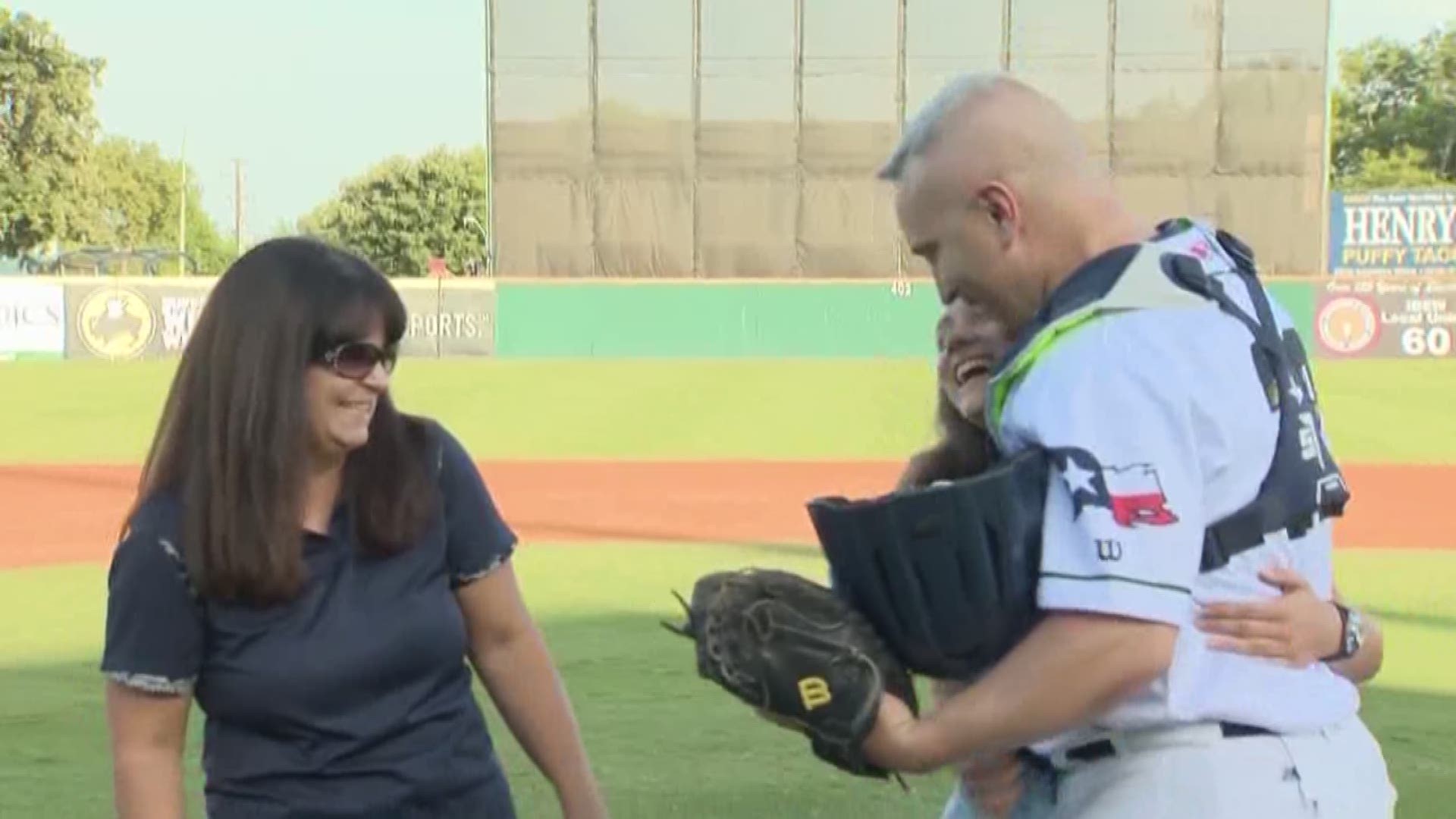 They thought they were just throwing the ceremonial first pitch. Captain Lowman disguised himself in full catcher's gear and caught the pitch before revealing himself to his family.