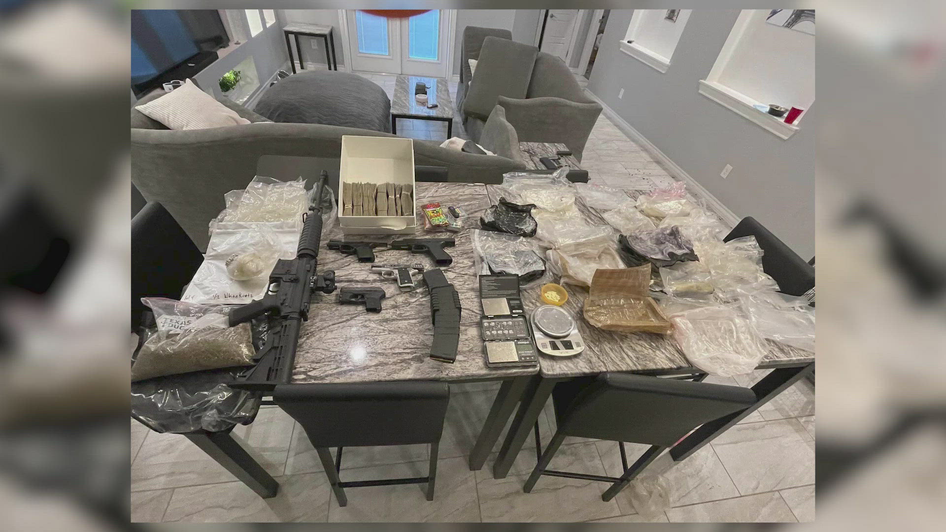 Five handguns, a rifle, jewelry valued over $30,000, cocaine, xanax pills, marijuana, THC, scales, money counting machines, and drug packaging were found, BCSO says.