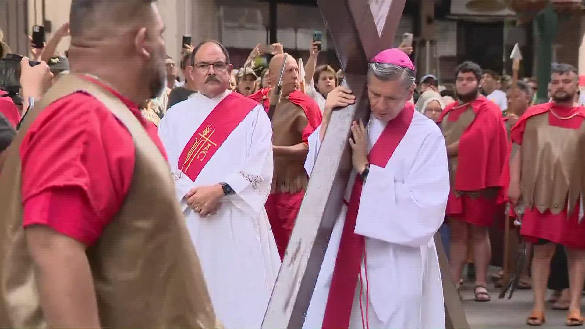 People are gathered outside the San Fernando Cathedral.