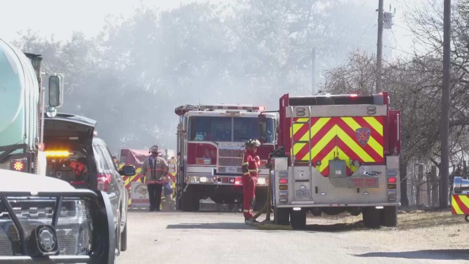 A small army of utility workers showed up in a still smoldering area south of Somerset, where a wildfire raced through a rural neighborhood near Royal Oaks Tuesday.