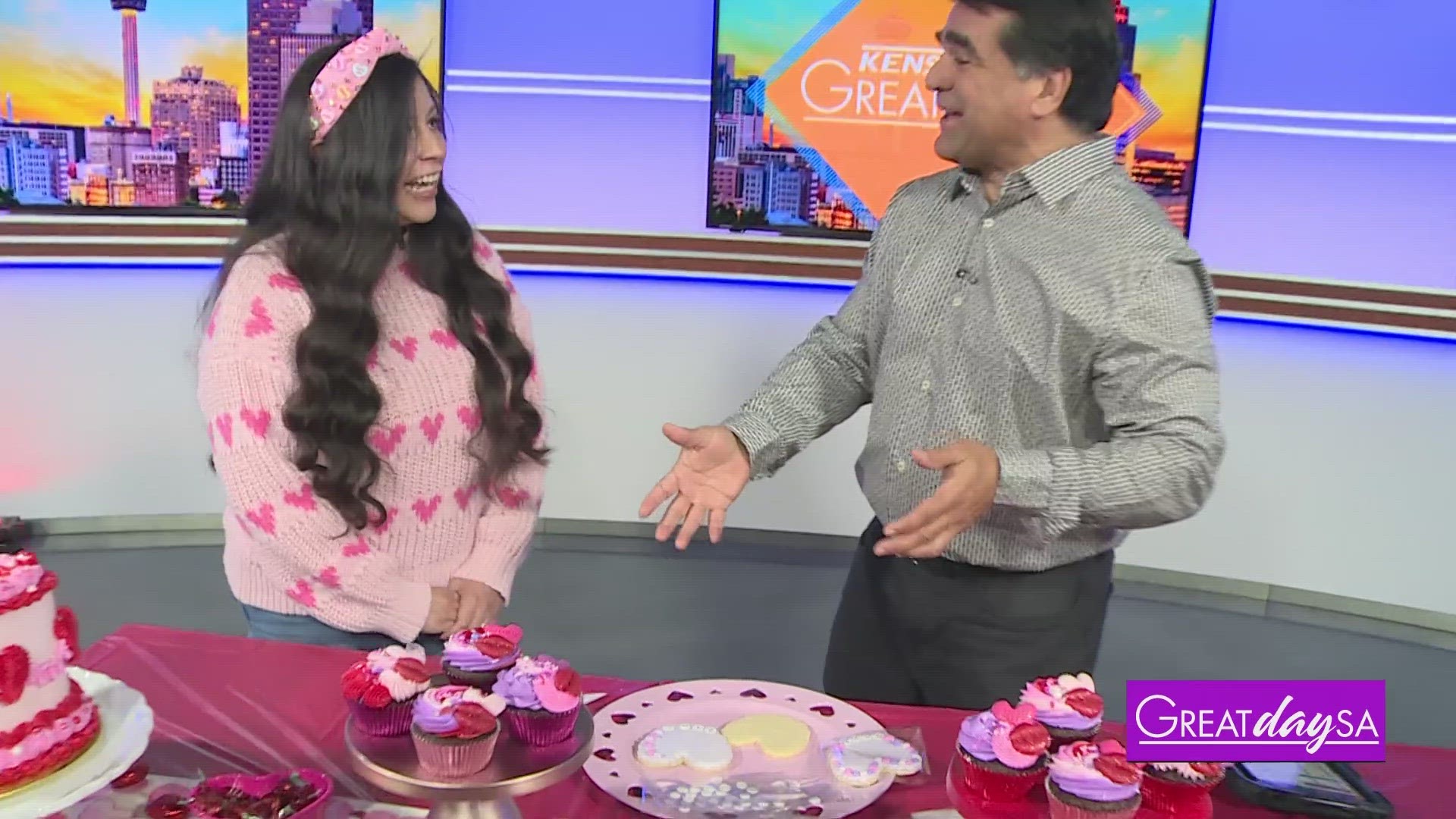 Laurie Avila McDonald with Adi Beat Sweets shows Paul how to decorate a Valentine's Day cookie.