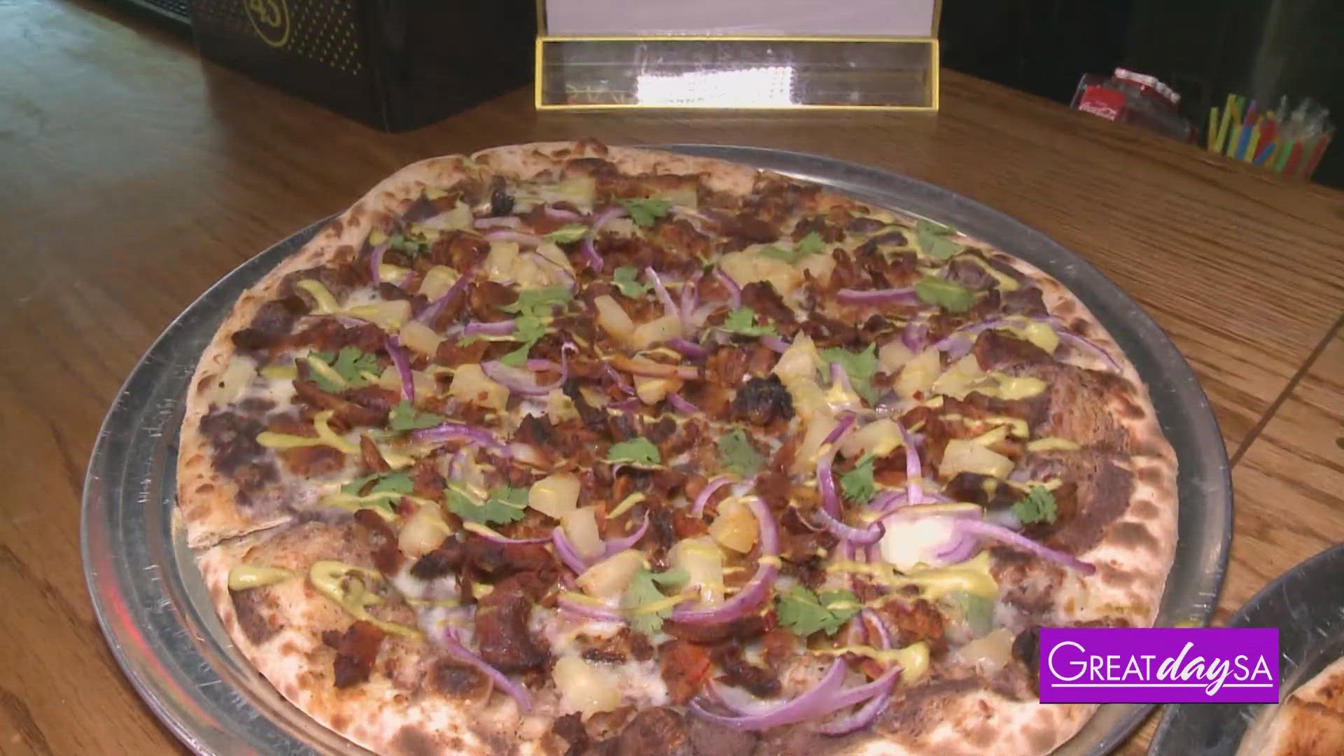 Multi-Skilled Journalist Justin Calderon helps make a delicious pizza at Boombox Pizza Bar.