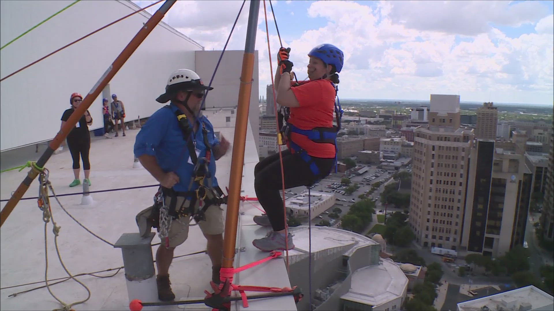 People repel down the 20-story Thompson San Antonio Riverwalk Hotel in the downtown area.