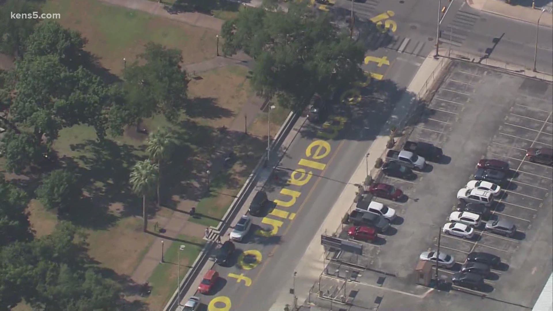 The message is a poem paint on a downtown San Antonio street, and the words come from a local poet laureate.