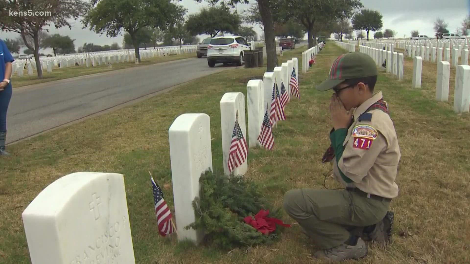 Volunteers are at Fort Sam Houston National Cemetery laying wreaths on more than 167,000 headstones.