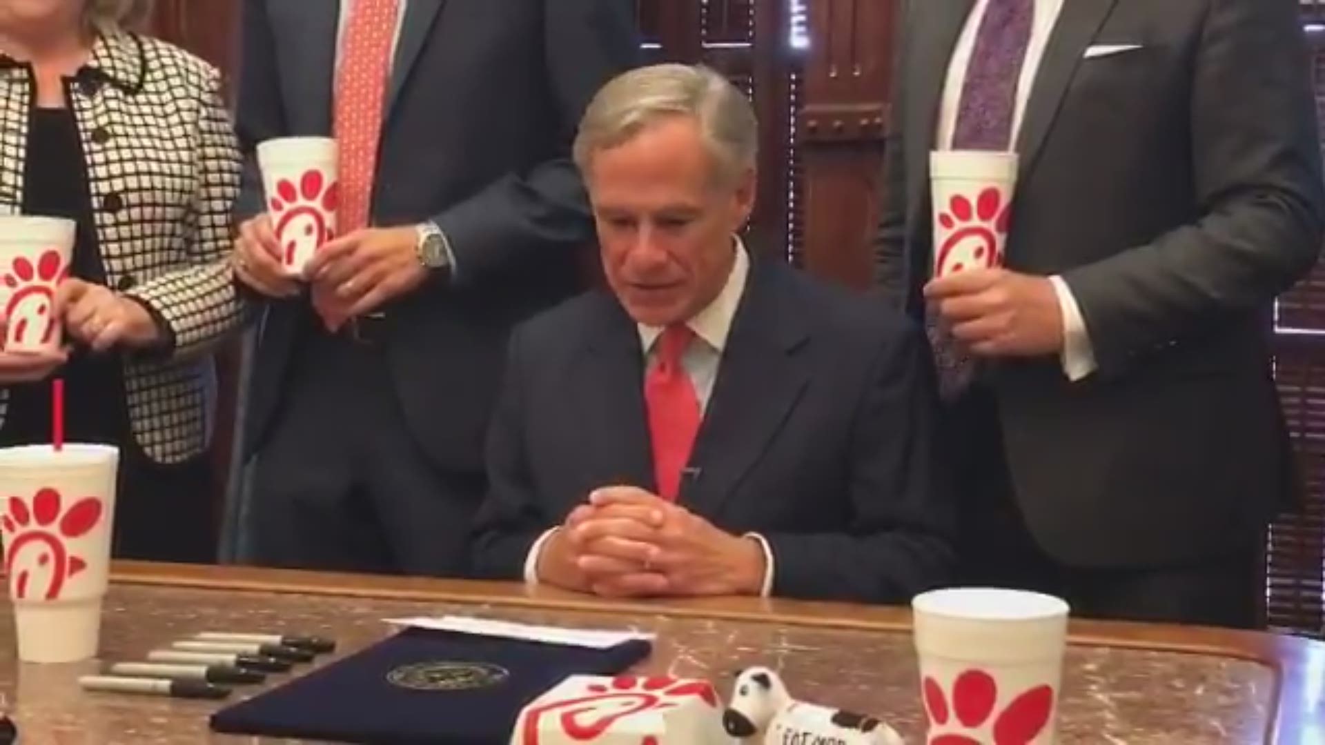 Governor Greg Abbott munched on some Chick-fil-A as he signed the so-called "Chick-fil-A"' law.