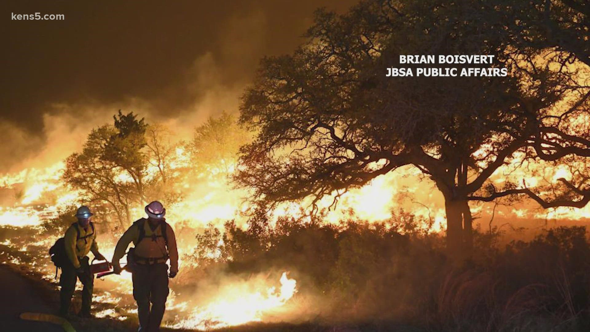 The brush fire started in an active training area Saturday, according to Joint Base San Antonio. Two neighborhoods were asked to evacuate on the far northwest side.