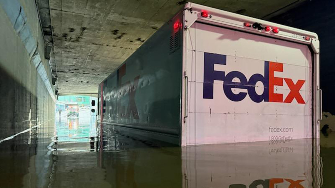 Houston flooding: FedEx driver rescued after truck stuck in high water ...