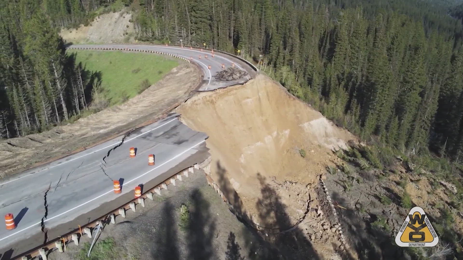 Aerial photos and drone video of the collapse show the Teton Pass road riven with deep cracks, and a big section of the pavement disappeared altogether.