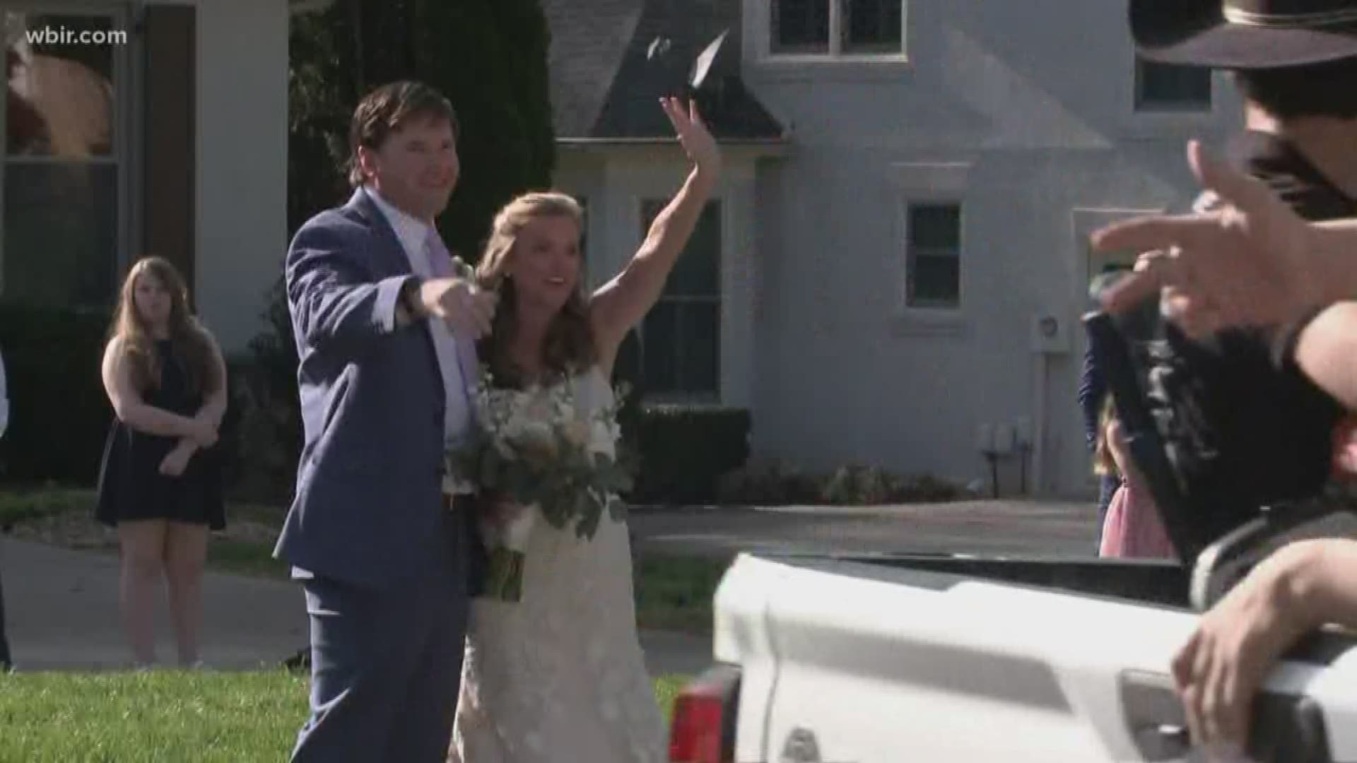 They couldn't have their friends at their ceremony... but they were still able to celebrate by having everyone drive by and wave.