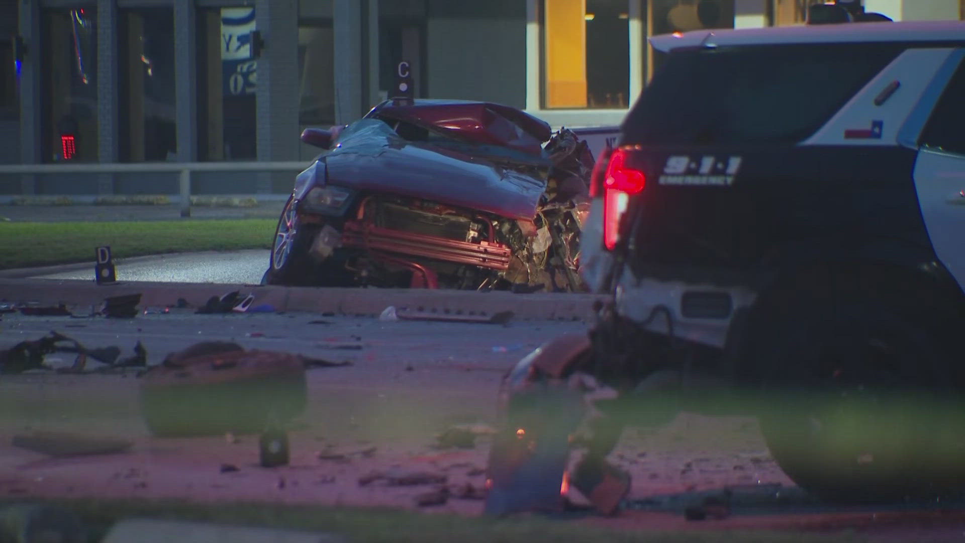 Two Dallas police officers were injured and one person was killed in a crash early Friday.