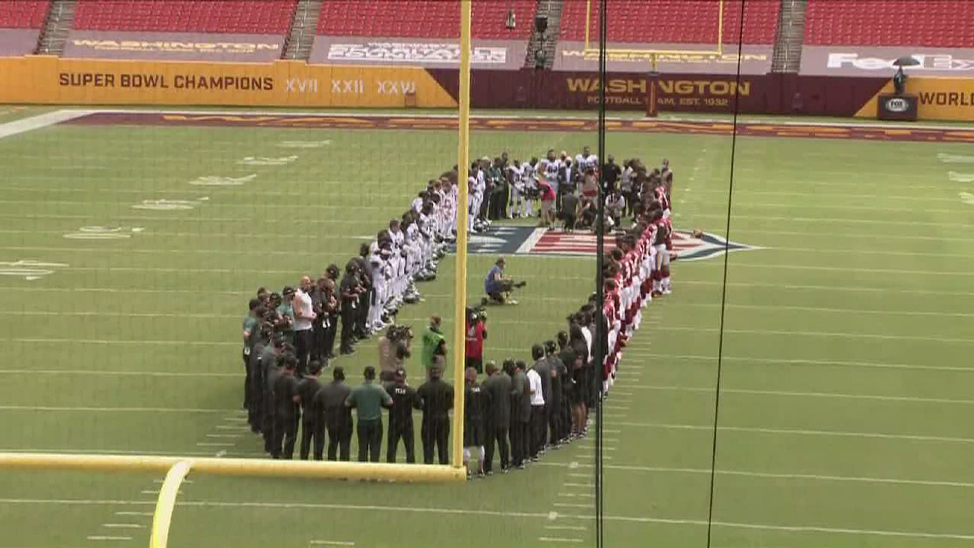 The players formed a circle to the sound of the Black National Anthem “Lift Every Voice and Sing.”